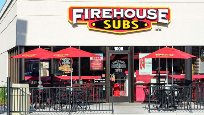 Firehouse subs located in Novato, California. Exterior of the location with tables and chairs on outdoor patio.