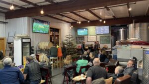 Pods Tap room hosting an event filled with people in Downtown Novato