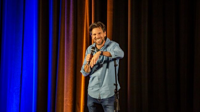 Comedian Don Friesen performing stand up comedy.