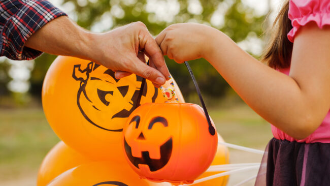 Little kid girl trick or treating on Halloween.